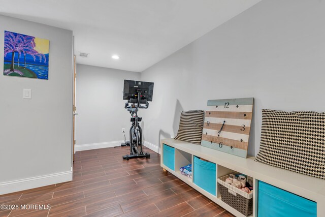 exercise area with baseboards, recessed lighting, visible vents, and dark wood-style floors