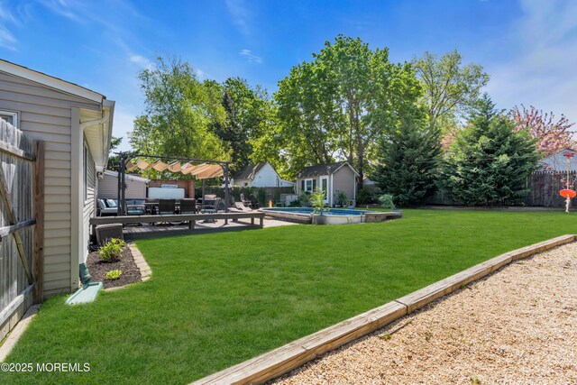 view of yard with an outdoor structure, a fenced backyard, a patio area, and a fenced in pool