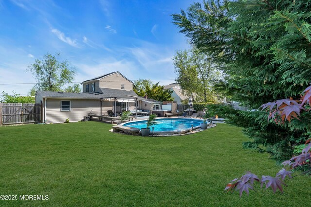 view of pool featuring a yard, a pergola, a fenced in pool, and a fenced backyard