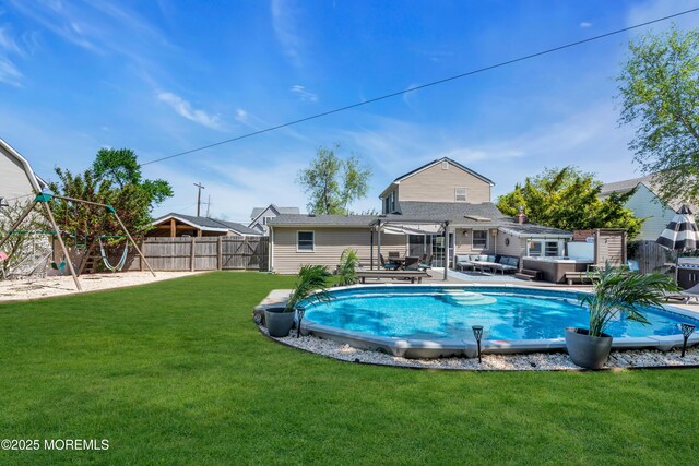 view of swimming pool featuring an outdoor living space, a lawn, a fenced in pool, a fenced backyard, and a pergola