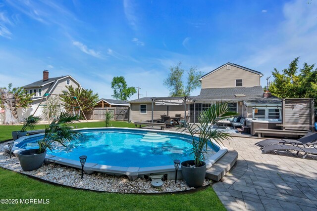 view of swimming pool featuring a pergola, a hot tub, a fenced backyard, a fenced in pool, and a patio area