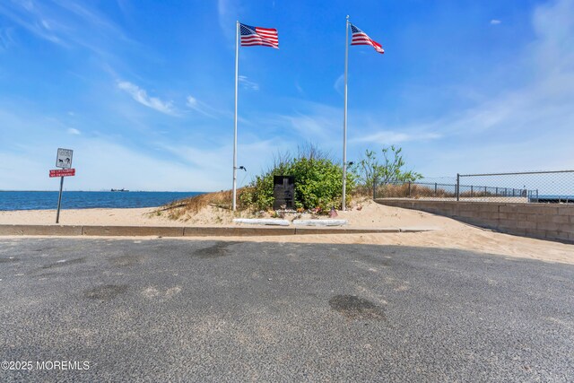 view of road with a beach view and a water view