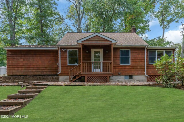 188 Five Points Rd, Colts Neck, NJ 07722 - view of front of house with roof with shingles, a chimney, and a front lawn