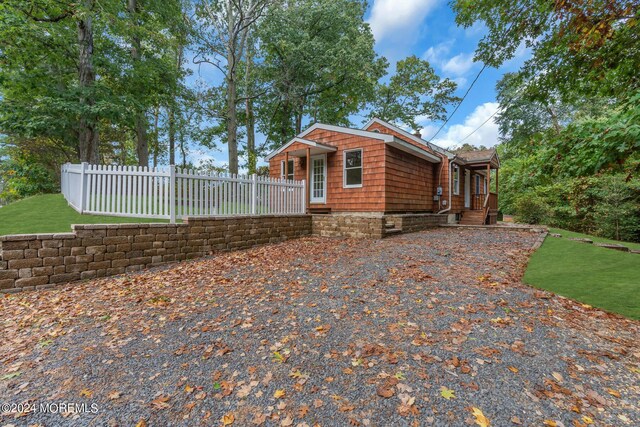 188 Five Points Rd, Colts Neck, NJ 07722 - view of home's exterior with fence, a lawn, and a porch