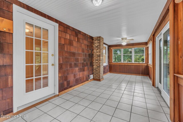 188 Five Points Rd, Colts Neck, NJ 07722 - unfurnished sunroom featuring wooden walls, tile patterned floors, visible vents, and baseboards