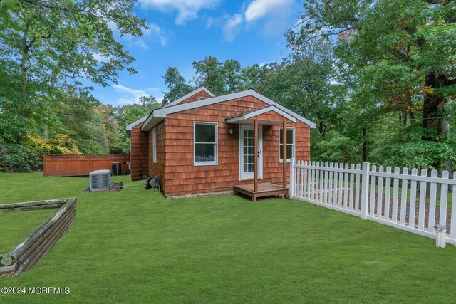 188 Five Points Rd, Colts Neck, NJ 07722 - exterior space with fence, an outdoor structure, central AC, and a front yard