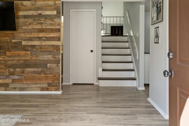 staircase with baseboards and wood finished floors