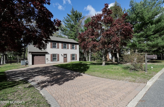 colonial house with a garage, a front lawn, decorative driveway, roof with shingles, and central AC unit