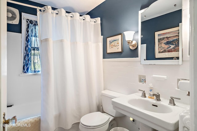 bathroom with a shower with curtain, visible vents, tile walls, a sink, and toilet