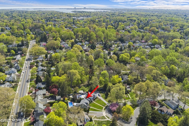 birds eye view of property with a residential view and a view of trees