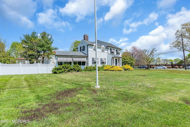 537 Cedar Ave, West Long Branch, NJ 07764 - rear view of house with a lawn, fence, and a chimney