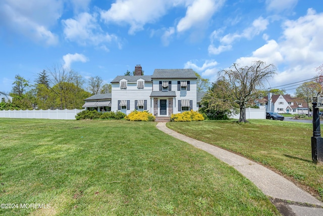 537 Cedar Ave, West Long Branch, NJ 07764 - view of front of property featuring fence, a chimney, and a front lawn