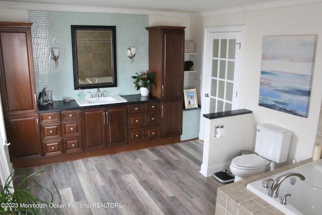 23 Layton Ave, Pine Beach, NJ 08741 - full bathroom featuring ornamental molding, toilet, a bath, wood finished floors, and vanity