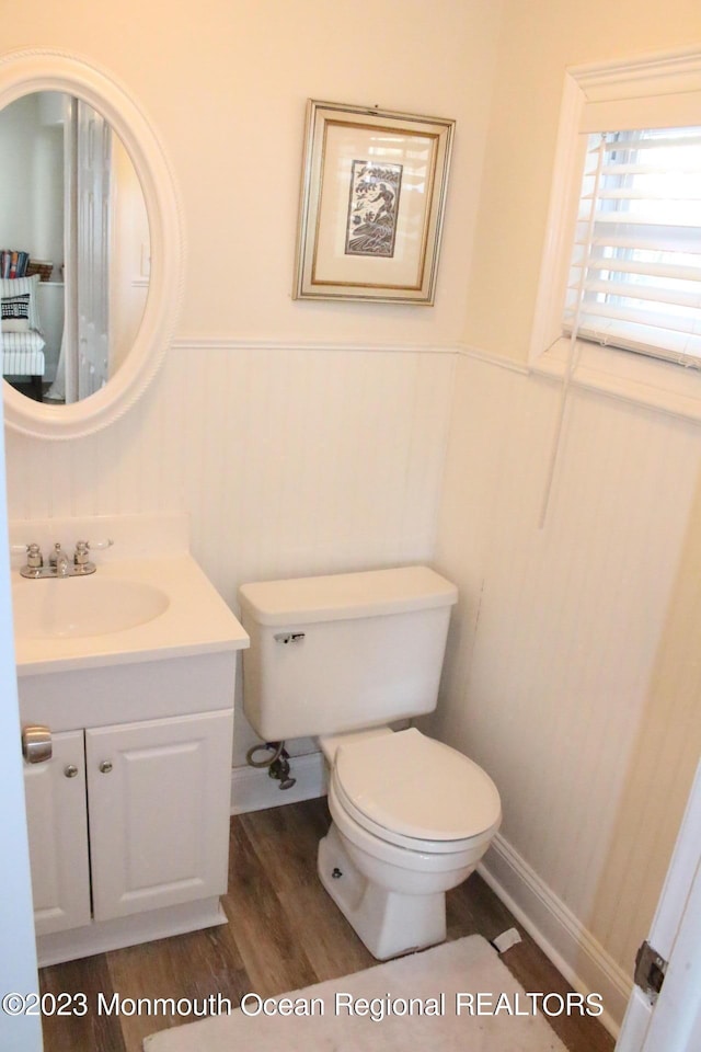 23 Layton Ave, Pine Beach, NJ 08741 - half bath featuring wood finished floors, wainscoting, toilet, and vanity