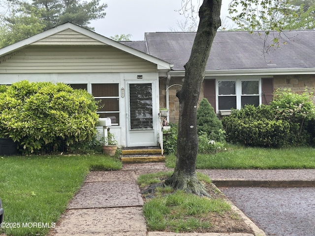 70 Sage Ct Unit A, Lakewood, NJ 08701 - view of front of home with a front yard, stone siding, and roof with shingles