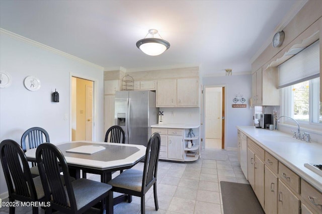 dining area featuring crown molding, baseboards, and light tile patterned floors