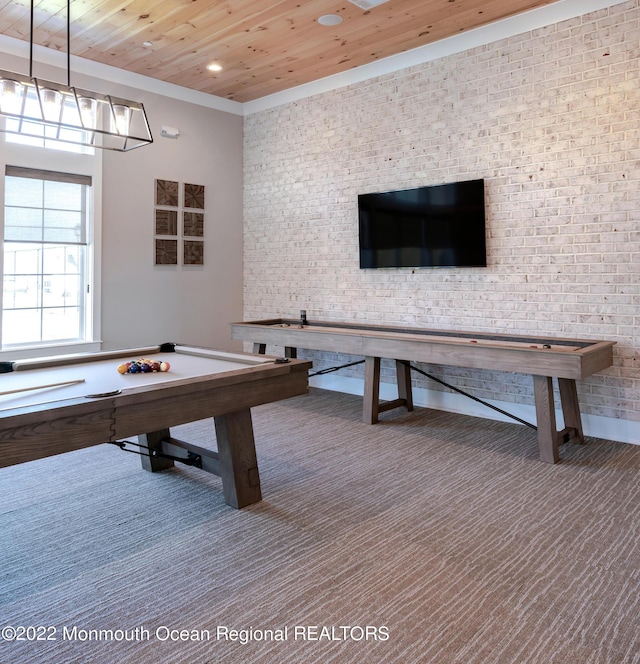 recreation room with carpet flooring, wood ceiling, and brick wall