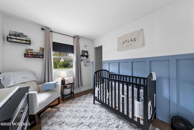 113 Darien Rd, Howell, NJ 07731 - bedroom with a nursery area, wood finished floors, wainscoting, and a decorative wall