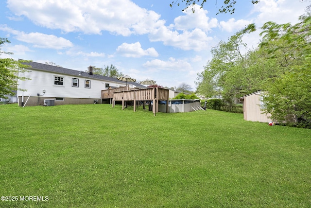 113 Darien Rd, Howell, NJ 07731 - view of grassy yard featuring a deck, a covered pool, a shed, an outbuilding, and cooling unit