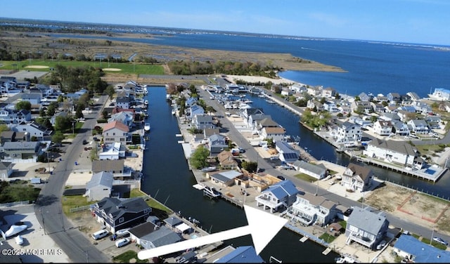 drone / aerial view with a water view and a residential view