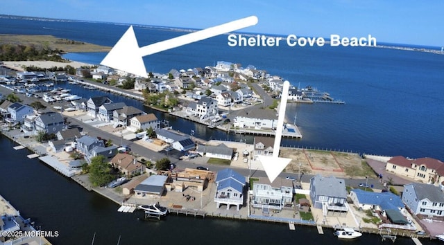 bird's eye view with a water view and a residential view