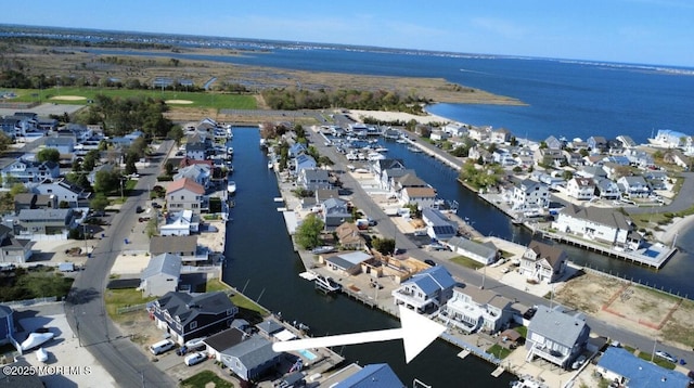 birds eye view of property featuring a water view and a residential view