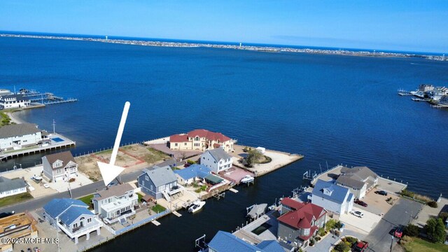 drone / aerial view with a water view and a residential view