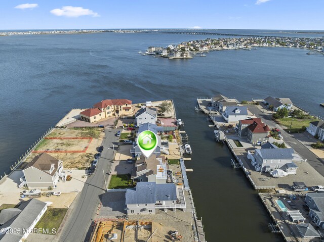 drone / aerial view with a water view and a residential view