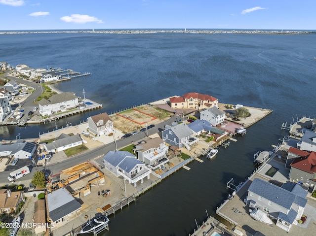 birds eye view of property with a water view and a residential view