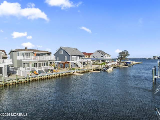 view of water feature featuring a residential view and a dock