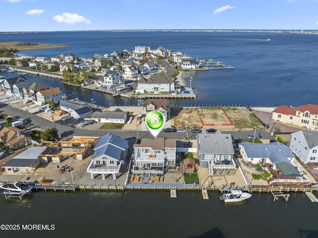 birds eye view of property featuring a water view and a residential view