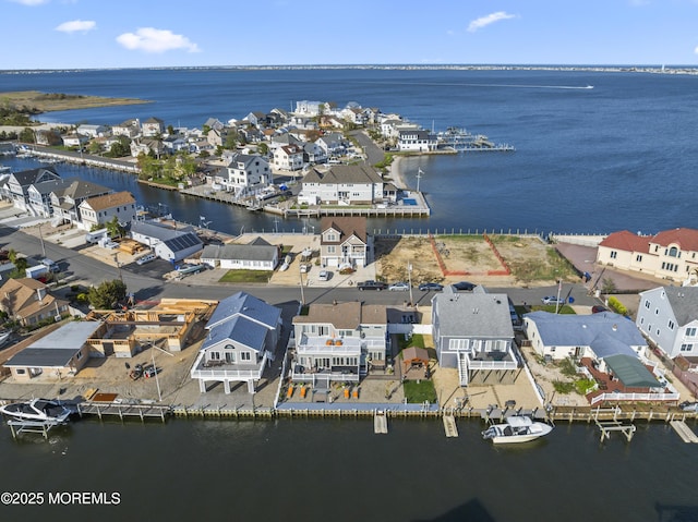 bird's eye view with a water view and a residential view