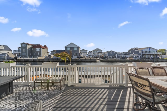 deck featuring a water view and a residential view