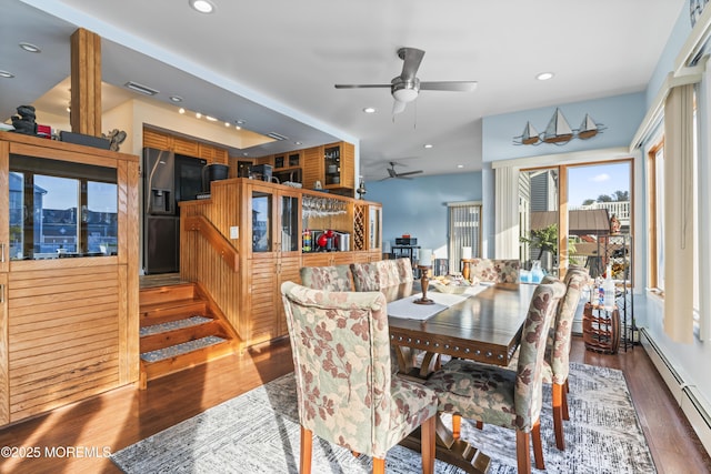 dining space with visible vents, wood finished floors, ceiling fan, recessed lighting, and a baseboard radiator