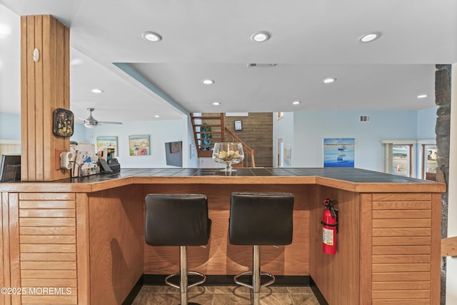 bar featuring recessed lighting, a ceiling fan, visible vents, and indoor bar