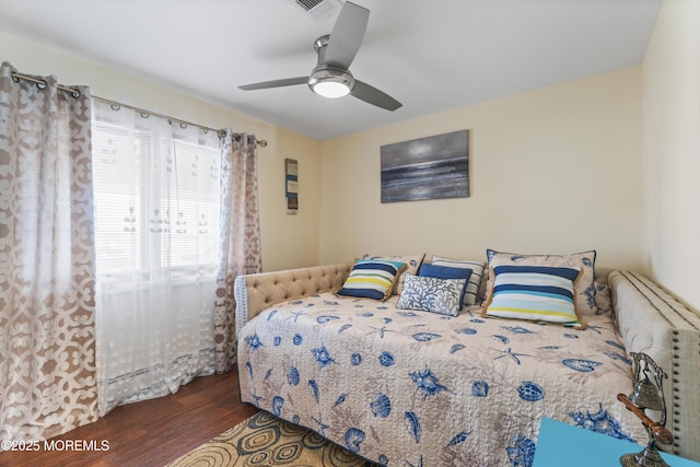 bedroom featuring ceiling fan, wood finished floors, and visible vents