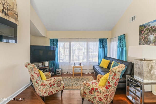 living room with baseboards, plenty of natural light, wood finished floors, and visible vents