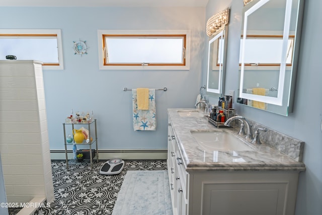 full bathroom with double vanity, baseboard heating, a baseboard heating unit, and a sink