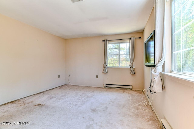 unfurnished room featuring a baseboard radiator, a baseboard heating unit, and carpet flooring