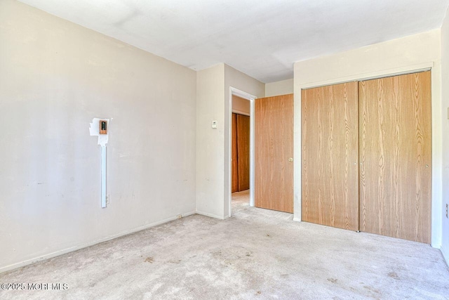 unfurnished bedroom featuring carpet floors and a closet