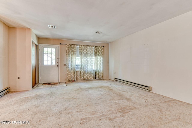 spare room with carpet floors, a baseboard radiator, and visible vents