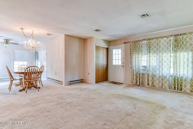 carpeted dining space featuring a chandelier, visible vents, and baseboard heating