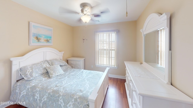 bedroom featuring baseboards, dark wood-style flooring, and ceiling fan