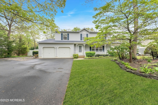 traditional home with a front lawn, aphalt driveway, and covered porch