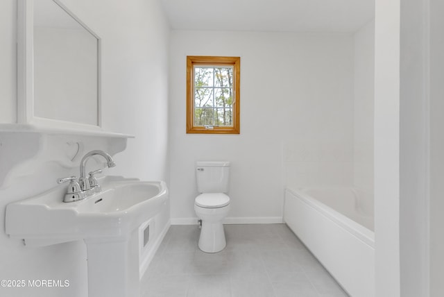 full bath with a tub, toilet, baseboards, and tile patterned flooring