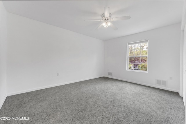 unfurnished room featuring baseboards, carpet floors, a ceiling fan, and visible vents