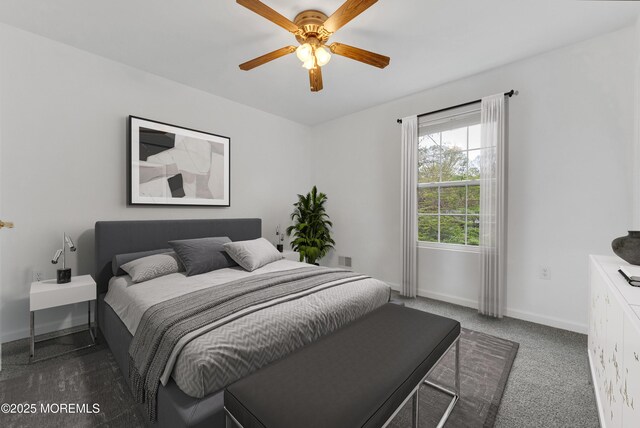 carpeted bedroom featuring baseboards, a ceiling fan, and visible vents