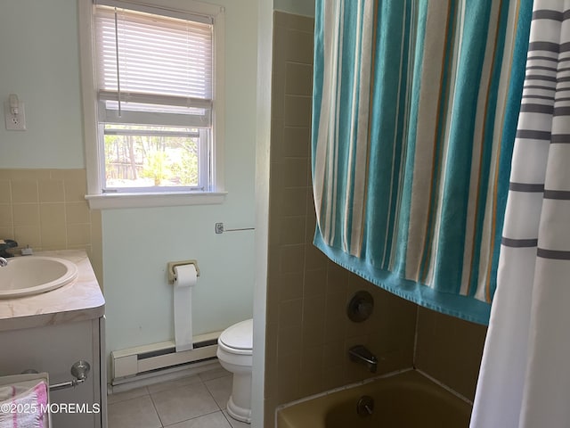 bathroom featuring tile patterned flooring, vanity, toilet, tile walls, and baseboard heating
