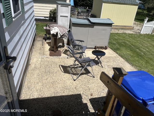 view of patio with a storage shed and an outdoor structure