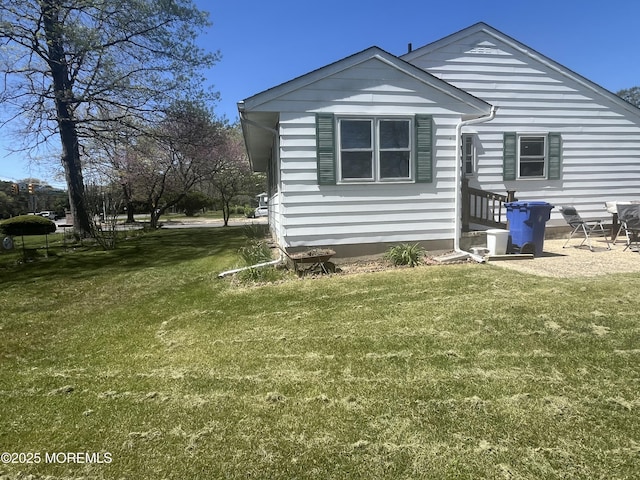 back of property with a lawn
